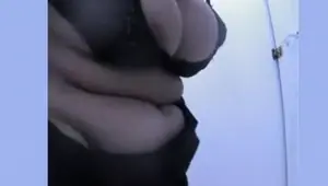 Chubby woman changing in beach cabin