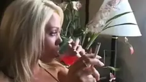 Gorgeous blonde girl smoking playing