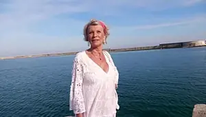 At 70, Eva takes a bite out of two young lads!